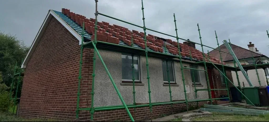 Scaffolded gable during a re-roof by Miro's Roofing & Building